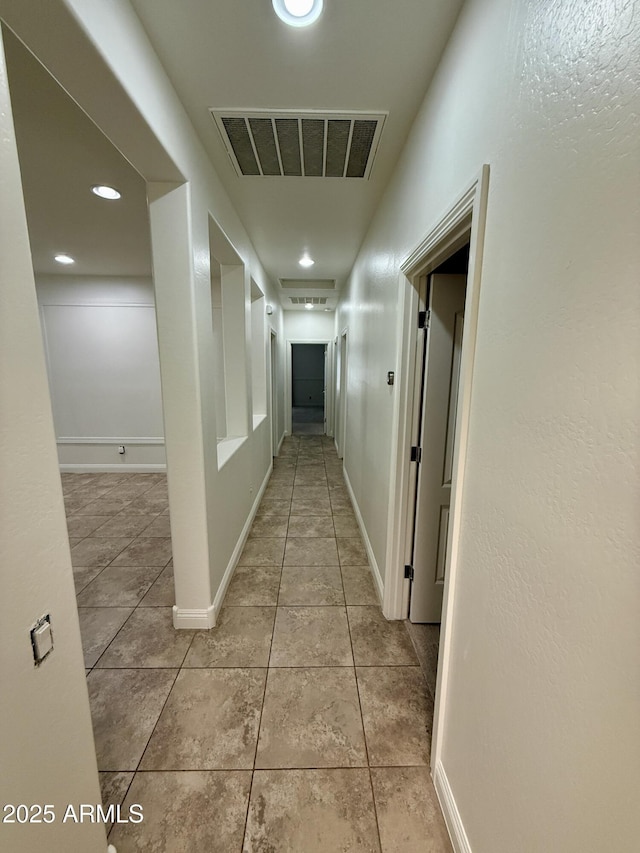 hall with light tile patterned flooring