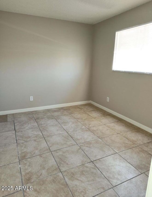 761 E Millett Ave, Mesa, AZ 85204 - empty room featuring light tile patterned floors, baseboards, and a textured ceiling