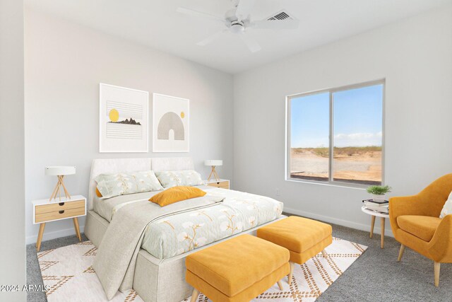 carpeted bedroom featuring a ceiling fan, visible vents, and baseboards