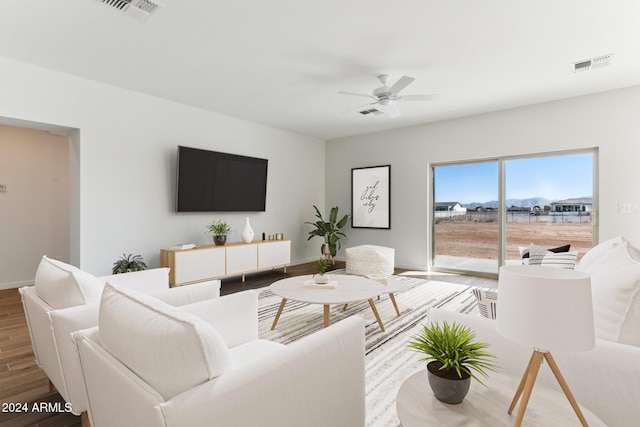 living room featuring visible vents, a ceiling fan, and wood finished floors