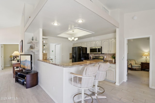 2055 N 56th St Unit 15, Mesa, AZ 85215 - kitchen featuring stainless steel appliances, a chandelier, light stone countertops, open shelves, and backsplash