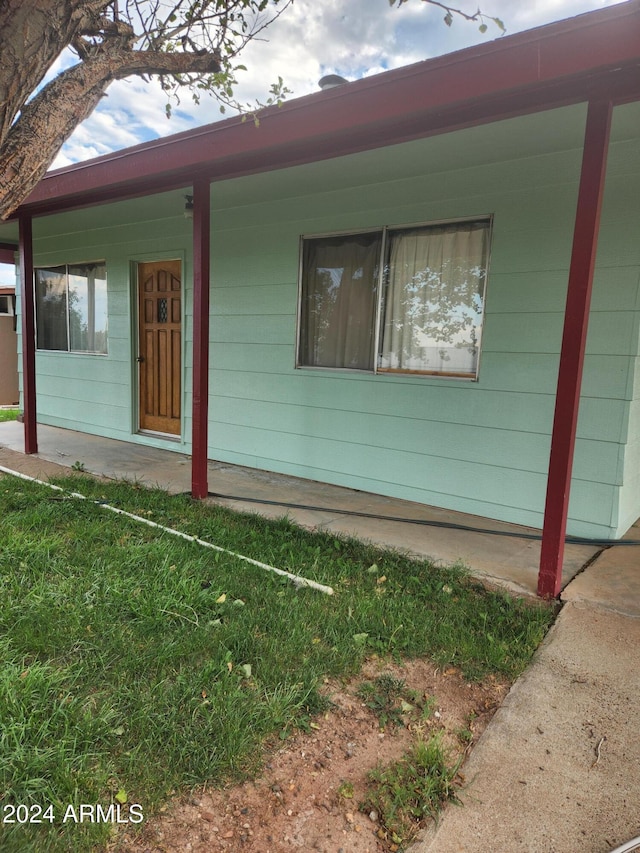 view of exterior entry with covered porch