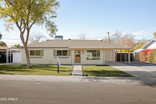 single story home featuring central AC, a front lawn, and a carport