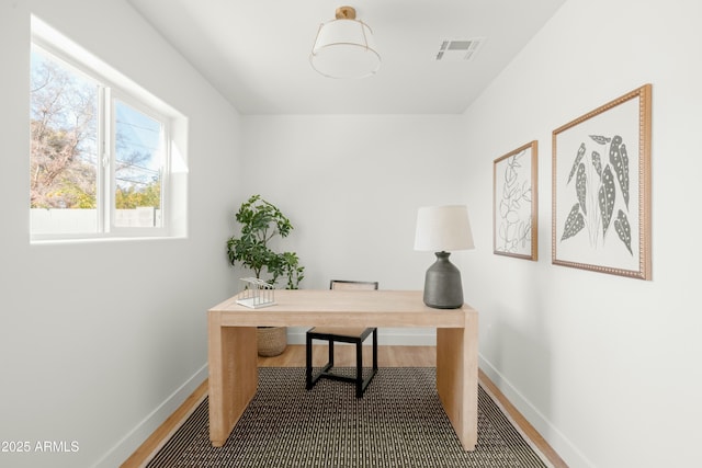 home office with hardwood / wood-style flooring