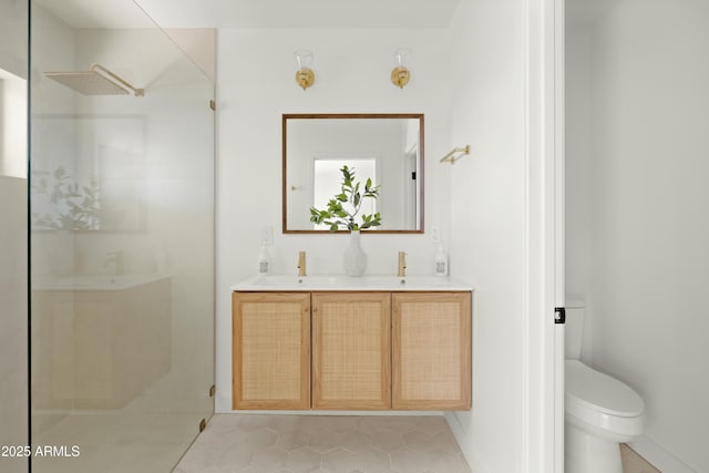 bathroom with toilet, a shower, vanity, and tile patterned floors