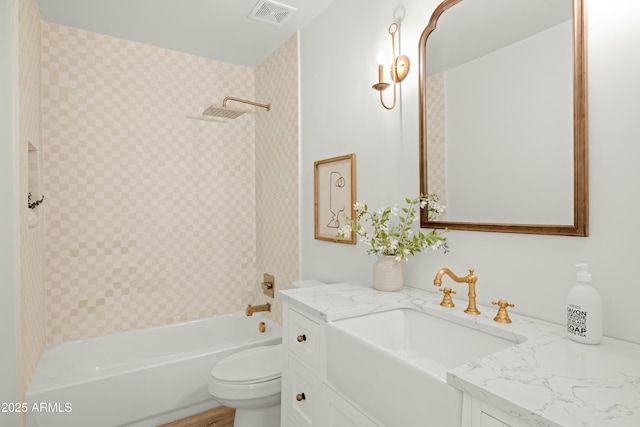 full bathroom featuring vanity, toilet, and washtub / shower combination