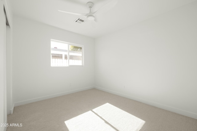 carpeted empty room featuring ceiling fan