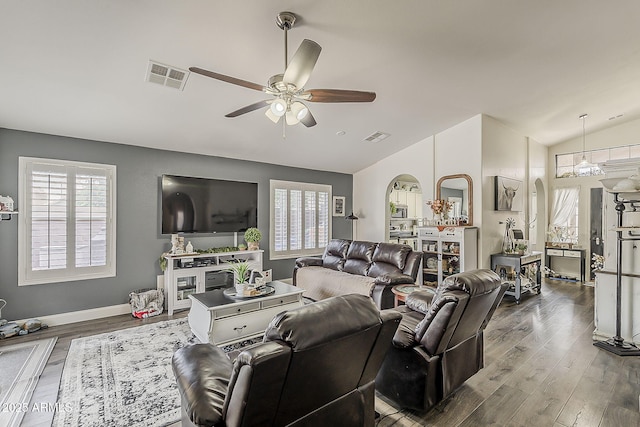 living area featuring lofted ceiling, ceiling fan, visible vents, and wood finished floors