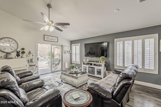 living area featuring a wealth of natural light, visible vents, wood finished floors, and a ceiling fan