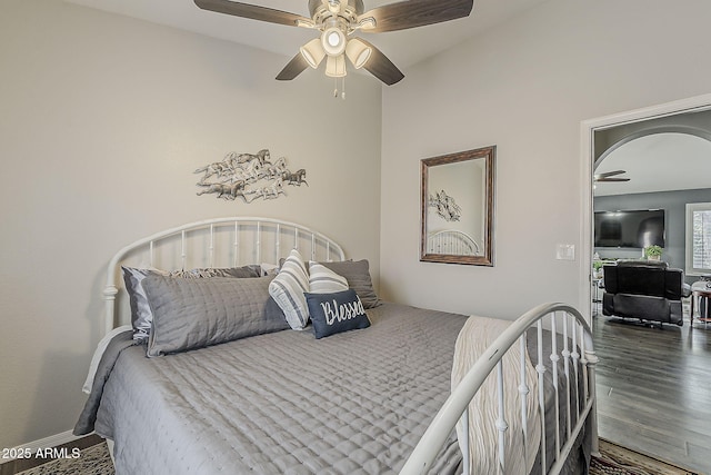 bedroom featuring ceiling fan, baseboards, and wood finished floors