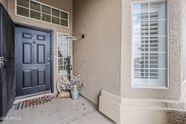 property entrance with stucco siding