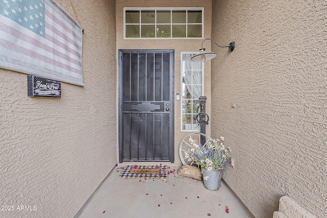 doorway to property with stucco siding