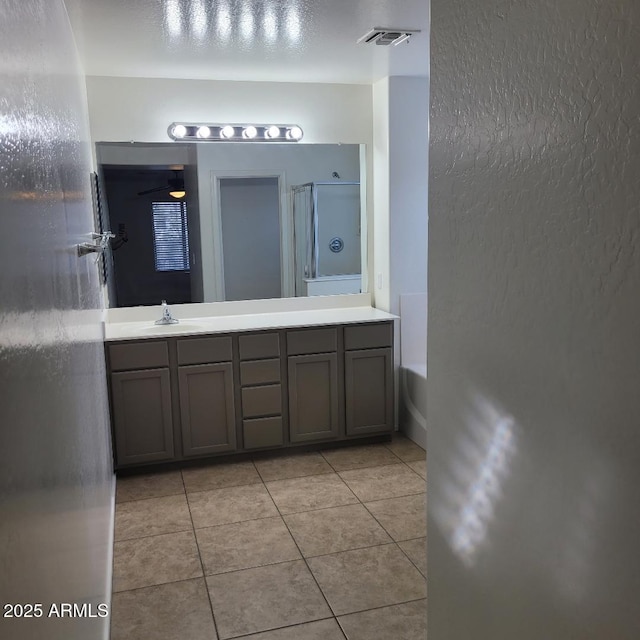 6908 S 8th Dr, Phoenix, AZ 85041 - bathroom with vanity, tile patterned floors, visible vents, a bath, and a stall shower