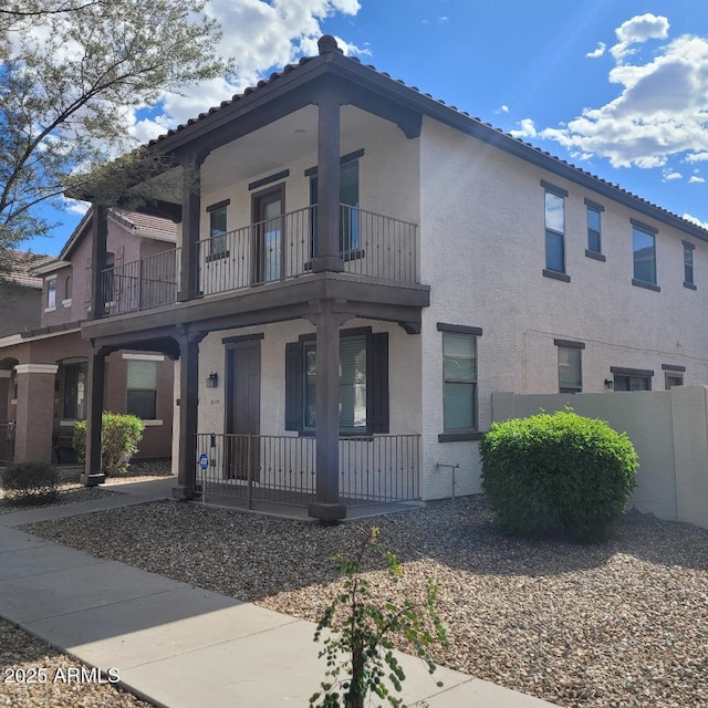 6908 S 8th Dr, Phoenix, AZ 85041 - view of front of house with covered porch, stucco siding, a tile roof, and a balcony