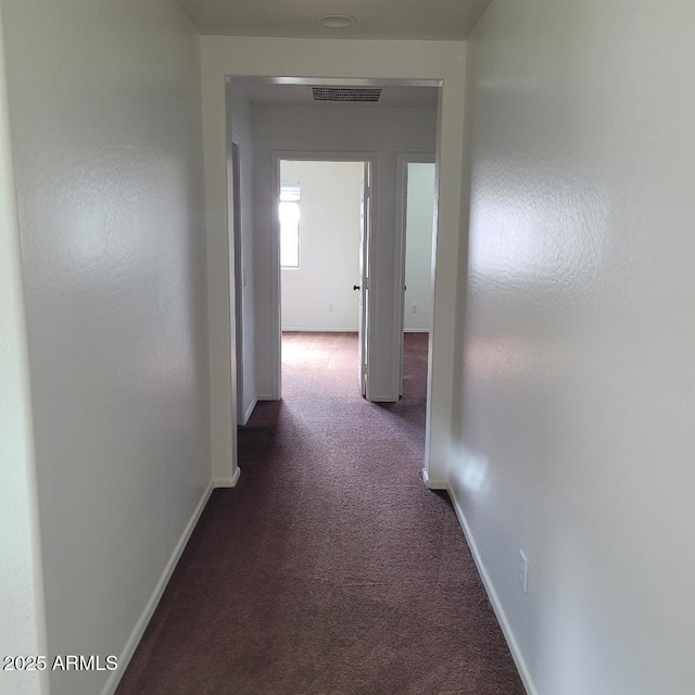 6908 S 8th Dr, Phoenix, AZ 85041 - hall featuring baseboards, visible vents, and dark colored carpet