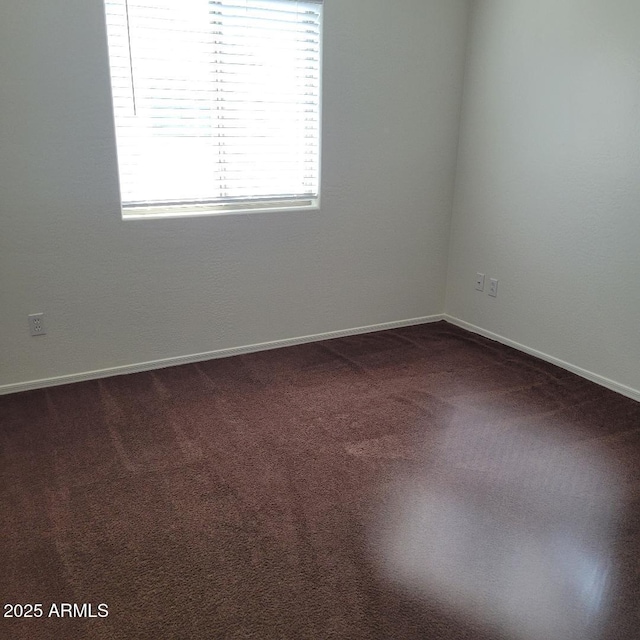 6908 S 8th Dr, Phoenix, AZ 85041 - empty room featuring dark carpet and baseboards