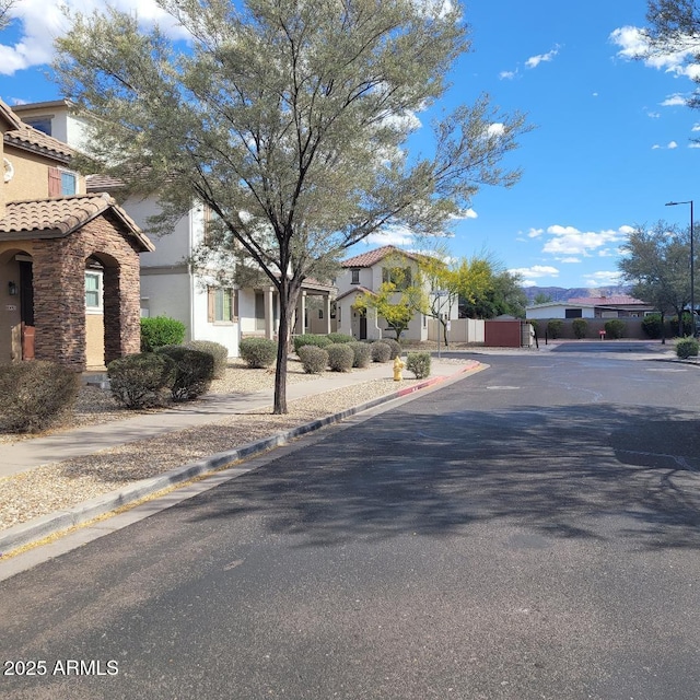 6908 S 8th Dr, Phoenix, AZ 85041 - view of road featuring a residential view, sidewalks, street lighting, and curbs