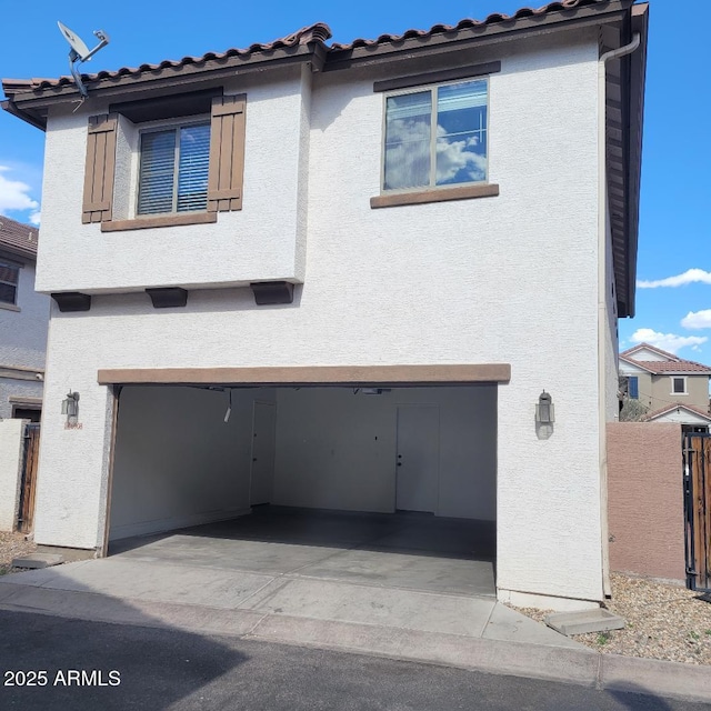 6908 S 8th Dr, Phoenix, AZ 85041 - view of front of house with stucco siding, a garage, and fence