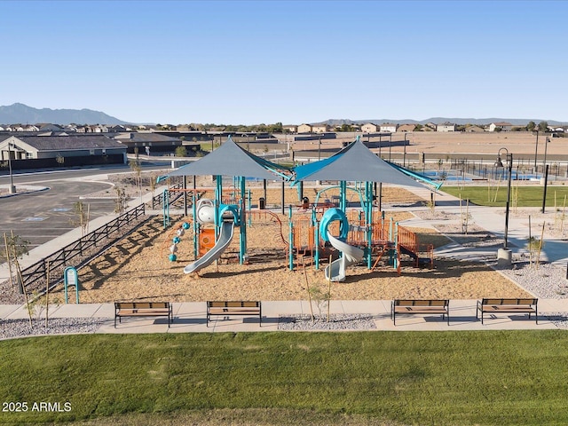 community play area with a mountain view and a lawn