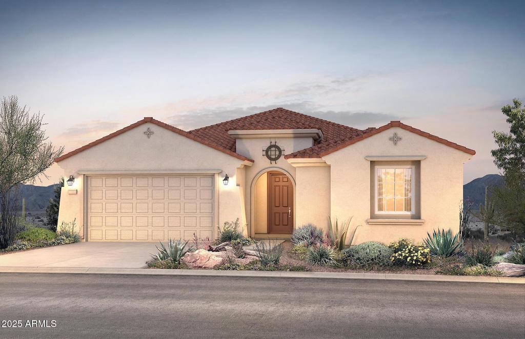 17636 W Pasadena Ave, Litchfield Park, AZ 85340 - mediterranean / spanish-style home featuring concrete driveway, an attached garage, and stucco siding