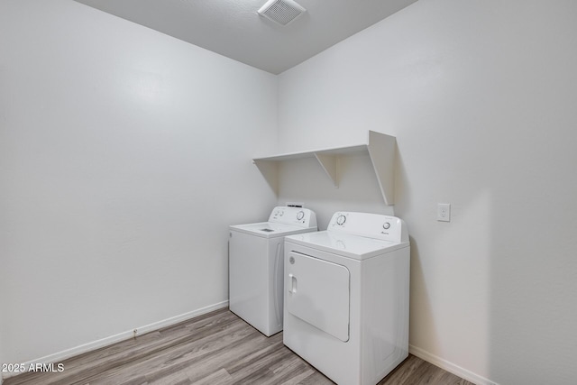 17728 W Paraiso Dr, Surprise, AZ 85387 - laundry area featuring washer and clothes dryer, light wood-style flooring, and baseboards
