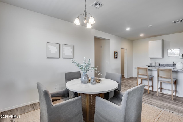 17728 W Paraiso Dr, Surprise, AZ 85387 - dining space with light wood-style flooring, baseboards, a chandelier, and recessed lighting