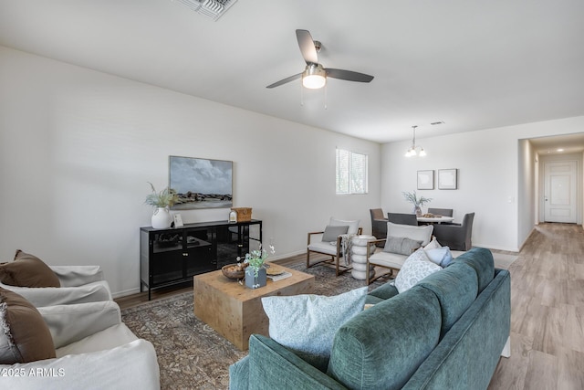 17728 W Paraiso Dr, Surprise, AZ 85387 - living room featuring ceiling fan, light wood-style floors, and baseboards