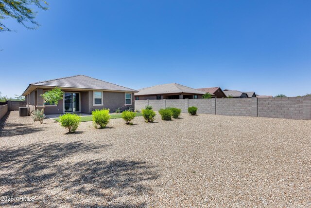 17728 W Paraiso Dr, Surprise, AZ 85387 - rear view of house featuring a fenced backyard, a tiled roof, central AC unit, and stucco siding