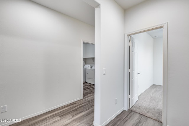 17728 W Paraiso Dr, Surprise, AZ 85387 - hallway with washer and dryer, wood finished floors, and baseboards