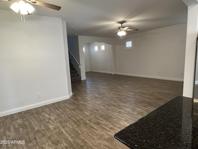 3480 E Sheffield Rd, Gilbert, AZ 85296 - unfurnished living room featuring a ceiling fan, arched walkways, wood finished floors, and stairway