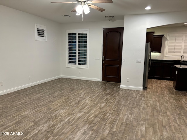 3480 E Sheffield Rd, Gilbert, AZ 85296 - unfurnished living room with ceiling fan, wood finished floors, and recessed lighting