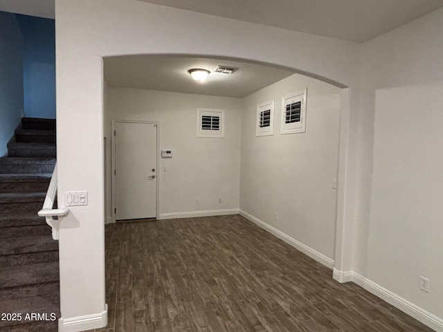 3480 E Sheffield Rd, Gilbert, AZ 85296 - below grade area featuring dark wood-type flooring, stairway, and arched walkways