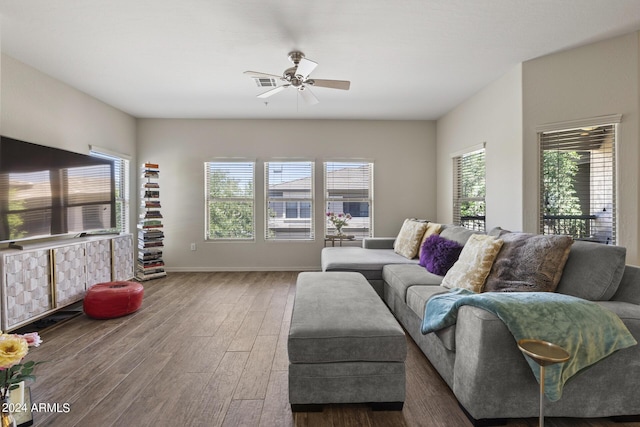 living room with ceiling fan, a wealth of natural light, and dark hardwood / wood-style floors