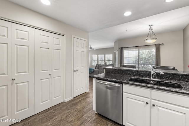 kitchen with dark stone counters, sink, white cabinetry, decorative light fixtures, and stainless steel dishwasher