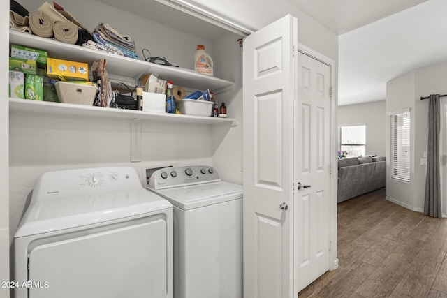 washroom with separate washer and dryer and hardwood / wood-style flooring