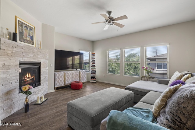 living room with a fireplace, ceiling fan, dark hardwood / wood-style flooring, and plenty of natural light