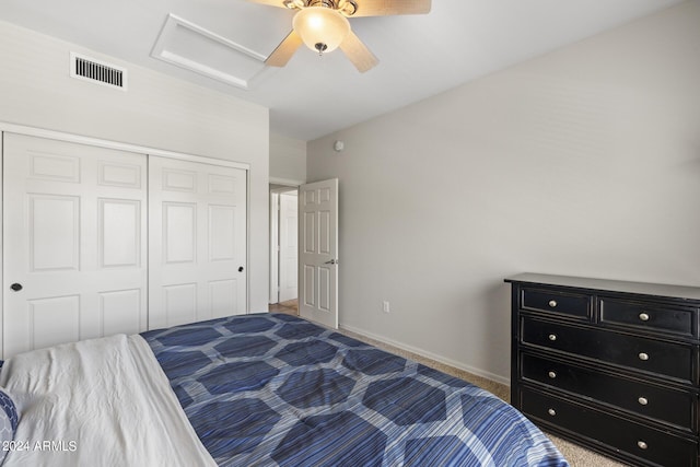 carpeted bedroom with ceiling fan and a closet