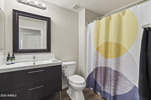 bathroom with toilet, hardwood / wood-style flooring, a textured ceiling, a shower with curtain, and vanity