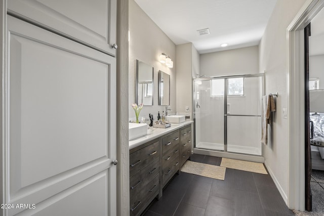 bathroom with vanity and a shower with shower door