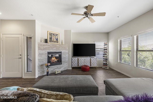 living room with a fireplace, ceiling fan, and dark hardwood / wood-style floors