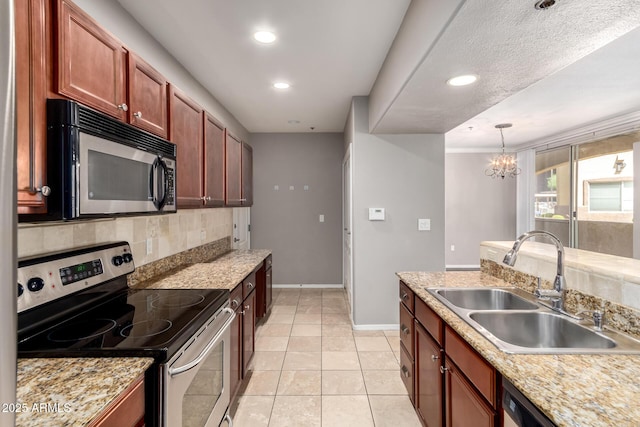 2134 E Broadway Rd Unit 1062, Tempe, AZ 85282 - kitchen featuring stainless steel appliances, a sink, backsplash, baseboards, and light countertops