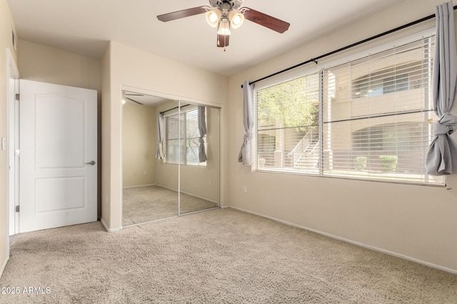 2134 E Broadway Rd Unit 1062, Tempe, AZ 85282 - unfurnished bedroom with carpet, a closet, baseboards, and a ceiling fan