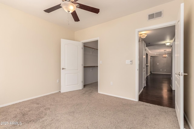 2134 E Broadway Rd Unit 1062, Tempe, AZ 85282 - unfurnished bedroom featuring carpet flooring, a walk in closet, baseboards, and ceiling fan