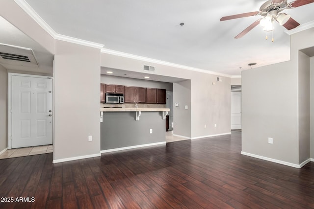 2134 E Broadway Rd Unit 1062, Tempe, AZ 85282 - unfurnished living room with ceiling fan, crown molding, baseboards, and wood-type flooring