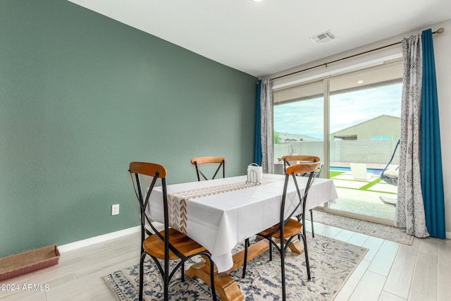 dining space with light hardwood / wood-style floors