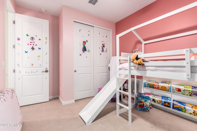 bedroom featuring a closet and light colored carpet