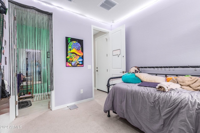 bedroom with light colored carpet