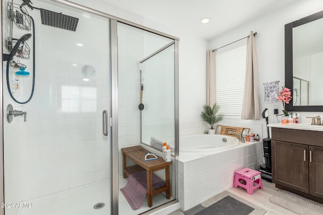 bathroom with shower with separate bathtub, vanity, and tile patterned floors