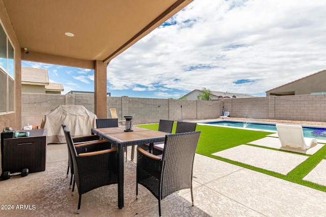 view of patio featuring a fenced in pool