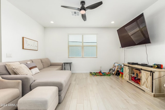 living room with ceiling fan and light hardwood / wood-style floors